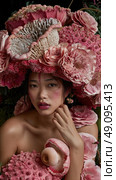 A woman is posed with a crown of pink flowers and a mushroom corsage. Стоковое AI-изображение, AI-художник Данила Большаков / Фотобанк Лори