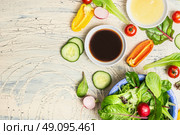 Fresh dressing and organic lettuce and vegetables for healthy salad on light rustic kitchen table, top view, place for text. Healthy  lifestyle or detox diet food  concept. Стоковое фото, агентство Ingram Publishing / Фотобанк Лори
