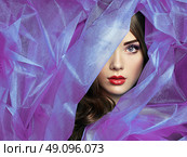 Fashion photo of beautiful women under purple veil. Beauty portrait. Perfect makeup. Eyelashes. Lips. Cosmetic Eyeshadow. Стоковое фото, агентство Ingram Publishing / Фотобанк Лори