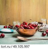 preparing of Sweet cherry preserve,  homemade jam or  jelly on rustic kitchen background. Стоковое фото, агентство Ingram Publishing / Фотобанк Лори