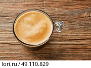 Coffee glass cup with cream on wooden table. Стоковое фото, агентство Ingram Publishing / Фотобанк Лори