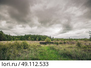 Small bunker in a military terrain in cloudy weather. Стоковое фото, агентство Ingram Publishing / Фотобанк Лори