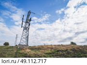 Large pylons with electrical wires over a dry field. Стоковое фото, агентство Ingram Publishing / Фотобанк Лори