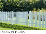 White picket fence in a garden in the summer. Стоковое фото, агентство Ingram Publishing / Фотобанк Лори