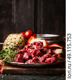 Raw diced beef meat  and organic vegetables ingredient  for Stew or goulash cooking. Food preparation on aged kitchen table at wooden background, top view. Стоковое фото, агентство Ingram Publishing / Фотобанк Лори