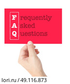 Frequently Asked Questions explained on a card held by a hand. Стоковое фото, агентство Ingram Publishing / Фотобанк Лори
