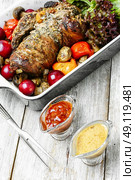 Meatloaf with stuffing. Meatloaf of veal stuffed with and assortment of sauces. Стоковое фото, агентство Ingram Publishing / Фотобанк Лори