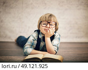 Clever boy reading a book. Стоковое фото, агентство Ingram Publishing / Фотобанк Лори