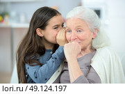 Little girl and grandma whispering secrets. Стоковое фото, агентство Ingram Publishing / Фотобанк Лори