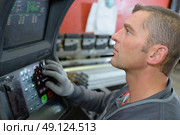industrial man technician worker at machine in factory workshop. Стоковое фото, агентство Ingram Publishing / Фотобанк Лори