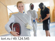 Portrait of smiling female fencer. Стоковое фото, агентство Ingram Publishing / Фотобанк Лори