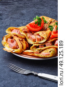 Pancakes for Shrove Tuesday. Tasty pancakes stuffed with meat and mushrooms on the plate. Стоковое фото, агентство Ingram Publishing / Фотобанк Лори