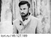 Outdoor portrait of handsome man in gray coat. Fashion photo. Beauty winter style. Black and White. Стоковое фото, агентство Ingram Publishing / Фотобанк Лори