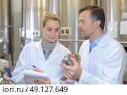 woman taking notes at a factory. Стоковое фото, агентство Ingram Publishing / Фотобанк Лори