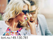 Handsome man telling his girlfriend something in privacy. Стоковое фото, агентство Ingram Publishing / Фотобанк Лори