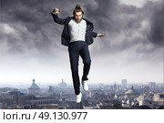 Fashion man jumping directly to the sky. Стоковое фото, агентство Ingram Publishing / Фотобанк Лори