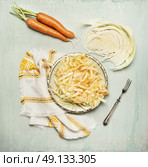 cabbage carrots salad in plate with fork and ingredients, top view composing. Стоковое фото, агентство Ingram Publishing / Фотобанк Лори