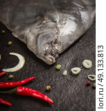 raw flounder head with spices on dark stone background. Стоковое фото, агентство Ingram Publishing / Фотобанк Лори