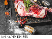 Raw meat mutton. Raw meat lamb shoulder blade on the kitchen board. Стоковое фото, агентство Ingram Publishing / Фотобанк Лори