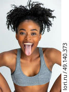 A woman sticking out her tongue in a playful and humorous gesture. Стоковое AI-изображение, AI-художник Данила Большаков / Фотобанк Лори
