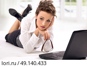 Miserable, young businesswoman thinkinh about career. Стоковое фото, агентство Ingram Publishing / Фотобанк Лори