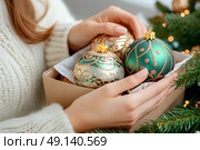 Девушка в белом теплом свитере с елочными шарами у рождественской ели. Украшение интерьера дома к зимним праздникам. Стоковое AI-изображение, AI-художник Щеголева Ольга / Фотобанк Лори
