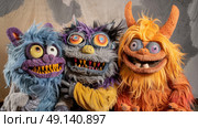 Three whimsical, furry puppets with vibrant colors and exaggerated features are sitting together, expressing joy and playfulness against a neutral backdrop. Стоковое AI-изображение, AI-художник Данила Большаков / Фотобанк Лори