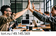 Two individuals celebrating by raising their hands and slapping them together in a mid-air gesture of congratulations. Стоковое AI-изображение, AI-художник Данила Большаков / Фотобанк Лори