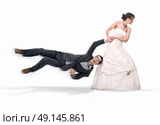 Portrait of a stubborn, young bride holding a groom. Стоковое фото, агентство Ingram Publishing / Фотобанк Лори