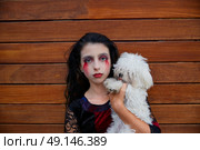 Halloween kid girl custome with bloody makeup on wooden wall. Стоковое фото, агентство Ingram Publishing / Фотобанк Лори