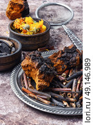 Healing gathering roots and herb. Medicinal herbs of folk medicine comfrey, inonotus obliquus and calendula. Стоковое фото, агентство Ingram Publishing / Фотобанк Лори