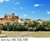 Cordoba, Spain. The Great Mosque (currently Catholic cathedral). UNESCO World Heritage Site. View with famous Roman Bridge and Guadalquivir river. Стоковое фото, агентство Ingram Publishing / Фотобанк Лори