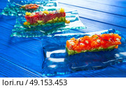 Salmon and Tuna Tartare with Anchovies tomato starter Tartar tapas. Стоковое фото, агентство Ingram Publishing / Фотобанк Лори