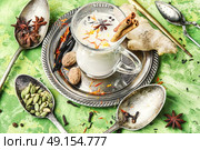 Masala tea ingredients. glass of Indian tonic tea with milk and spicy spices. Стоковое фото, агентство Ingram Publishing / Фотобанк Лори