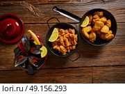 Fish seafood tapas adobo squid and steamed mussels of spain. Стоковое фото, агентство Ingram Publishing / Фотобанк Лори