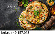 Homemade Kerala wheat paratha or layered parotta served with Paneer curry. Стоковое AI-изображение, AI-художник Anastasy Yarmolovich / Фотобанк Лори