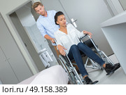 loving boy with his girlfriend in wheelchair in room. Стоковое фото, агентство Ingram Publishing / Фотобанк Лори