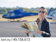 pilot holding a map with the background planes. Стоковое фото, агентство Ingram Publishing / Фотобанк Лори