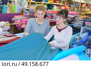 woman chooses scraps of colored tissue on table close up. Стоковое фото, агентство Ingram Publishing / Фотобанк Лори