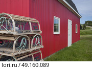 Stack of lobster traps outside fishing shed at harbor, Kensington, Prince Edward Island, Canada. Стоковое фото, агентство Ingram Publishing / Фотобанк Лори