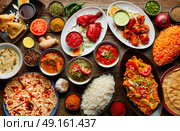 Assorted Indian recipes food various with spices and rice on wooden table. Стоковое фото, агентство Ingram Publishing / Фотобанк Лори