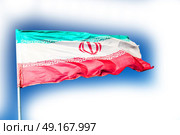 in iran blur  iranian waving flag  the blue sky and wind. Стоковое фото, агентство Ingram Publishing / Фотобанк Лори