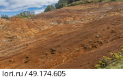 The famous 23 coloured earth of Mauritius. Colorful sand hill. Rocks on the slope. Green vegetation. Blue sky, clouds. La Vallée Des Couleurs Nature Park. Стоковое фото, фотограф Вера Ивановна Кубарева / Фотобанк Лори