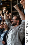 Group of diverse individuals gathered together, raising their hands in the air in unison. Стоковое AI-изображение, AI-художник Данила Большаков / Фотобанк Лори