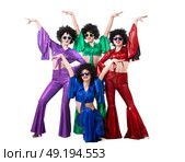 A group of girls in colorful flared suits and afro wigs pose against a white background. Disco style from the eighties or seventies. Стоковое фото, фотограф Лазаренко Светлана / Фотобанк Лори