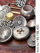 group of retro iron buttons. Large set of stylish old-fashioned metal buttons for clothes. Стоковое фото, агентство Ingram Publishing / Фотобанк Лори