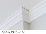 Ceiling close-up. Classic interior. LED Retrofit Bulb into Ceiling Fixture. Cornice. Installing. Decorative Ceiling crown molding intersection. Wall Corner Architecture Decor. Angular ceiling skirting. Стоковое AI-изображение, AI-художник Марина Демидюк / Фотобанк Лори