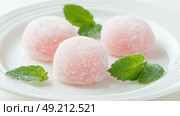 Delicious Japanese moti desserts. Close up. Asian rice daifuku dessert sweet mochi. Cut in half with filling. Traditional dessert mochi ice cream. Colorful rice cake. Fukashi manju. Culinary delights. Стоковое AI-изображение, AI-художник Марина Демидюк / Фотобанк Лори