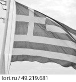 waving greece flag  in the   blue sky and      flagpole. Стоковое фото, агентство Ingram Publishing / Фотобанк Лори