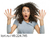 A woman with wide eyes and open mouth, hands at her face in surprise. Стоковое AI-изображение, AI-художник Данила Большаков / Фотобанк Лори